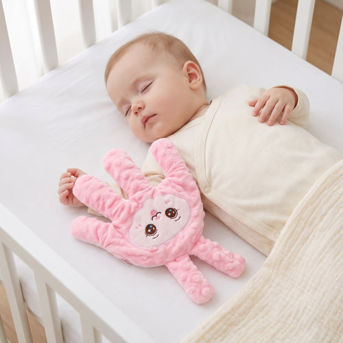 Baby Sleep Aid Patting Hand in pink bunny design, resting on a sleeping baby in a cot